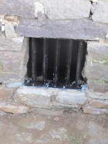 #17, 6940-DeTurk house cellar window with re-fabricated iron grille