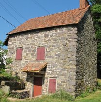 #3: NE view: Restored kitchen doorway, Door, hood, grilled cellar vent
