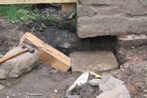 Image #2: bed stone set on clay sub-strate under plinth corner