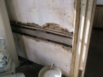 #1: Deteriorated and missing plaster along chair rail in store room