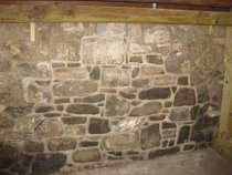 1304: Restored and re-pointed cellar wall at north gable end.