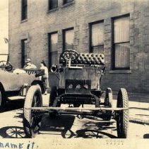 Very old automobile with buggy front suspension