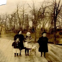 Four girls and a doll buggy