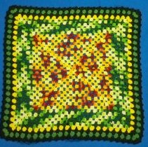 Crocheted granny square pillow cover