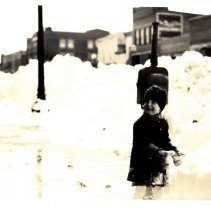 Child by the snow pile, Hutchinson, MN, 1924