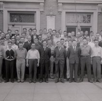 A group of men standing in front of McLeod County Courthouse