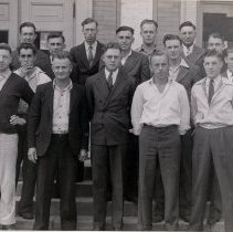 A group of men standing in front of McLeod County Courthouse