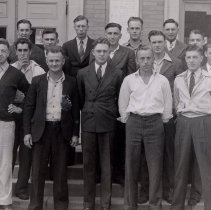 A group of men standing in front of McLeod County Courthouse