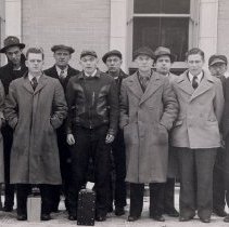 A group of men standing in front of McLeod County Courthouse