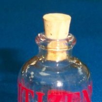 Novelty coin in bottle