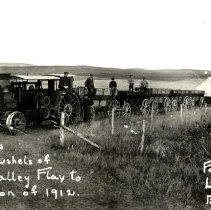 Steam driven tractors hauling flax,1912