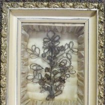 Showdowbox containing hair art floral arrangement