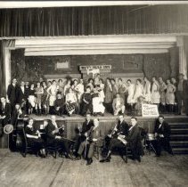 Actors on stage and eight piece orchestra