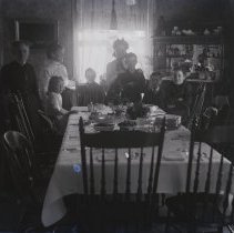 Luther W. Gilbert family in dining room (turkey)