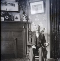 Luther w. Gilbert in living room, 1897
