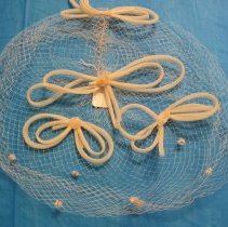 Pastel apricot colored net veil hat