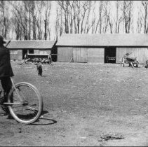 Arnold Daak on bicycle at home farm