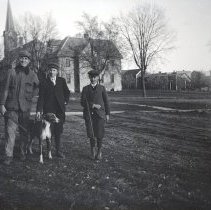 Unidentified young hunters and dog