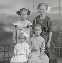 Four unidentified children with hair ribbons