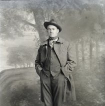 Unidentified man in hat & coat