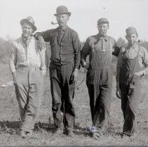 Group of four unidentified men with pipes