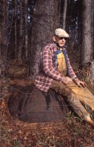Wilson Rowe sitting on cast-iron tar pot
