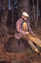 Wilson Rowe sitting on cast-iron tar pot