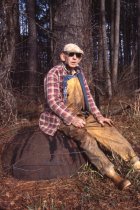 Wilson Rowe sitting on cast-iron tar pot