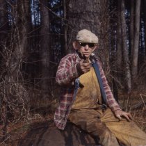 Wilson Rowe sitting on cast-iron tar pot