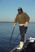 Roosevelt Wingfield tonging for oysters