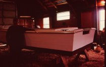 Willard Norris next to skiff