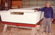 Willard Norris next to nearly complete 22' skiff