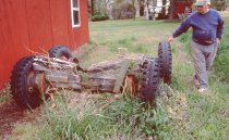 Willard Norris with dolly for hauling boats next to the Norris boatshop