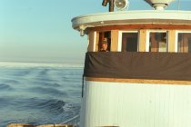 Dredge boat captain in the pilot house
