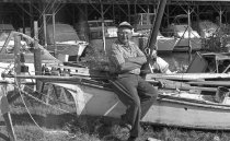 Willis Wilson sitting on a Wright skiff