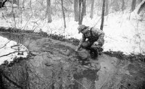 J.D. Davis checks a trap in icy creek waters