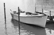 Green skiff moored on Broad Creek