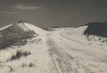 Chequessett Neck Road going showing a cut through the dunes, facing west