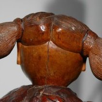 Back side of the attendant figure's head