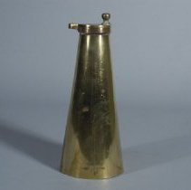Upside down brass grain funnel from grain scale