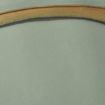 Side view of metal scythe blade