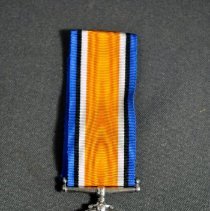 Front view of medal (a) and ribbon (b)