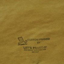 Close up of the framing logo on the back of the portrait.