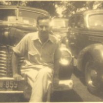 Man sitting on the front of a car
