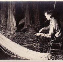 Percy Guthrie mending nets