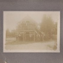 Men on porch and upstairs balcony