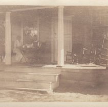 Man & woman sitting on front porch