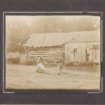 Couple in front of log cabin