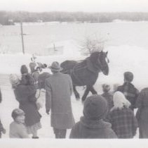 Santa riding on horse-drawn sleigh