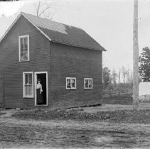 Woman standing in the doorway of a house
Woman standing in the doorway of a house
